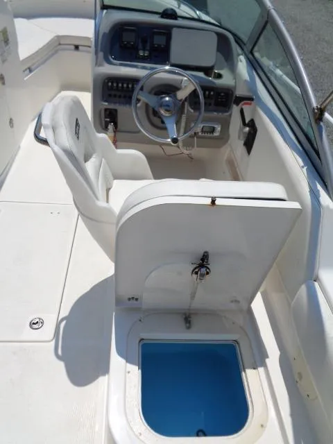 Slide: The Image of 2009 Robalo R227 Dual Console boat interior with steering wheel and storage compartment. - 20