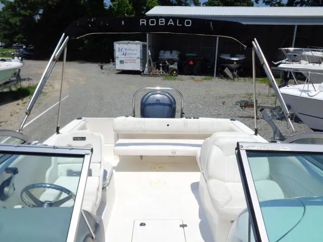Slide: The Image of 2009 Robalo R227 Dual Console boat interior with seating and steering wheel. - 23