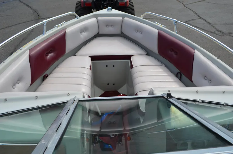 Slide: The Image of 1986 Four Winns Open Bow boat with red and white seating. - 3