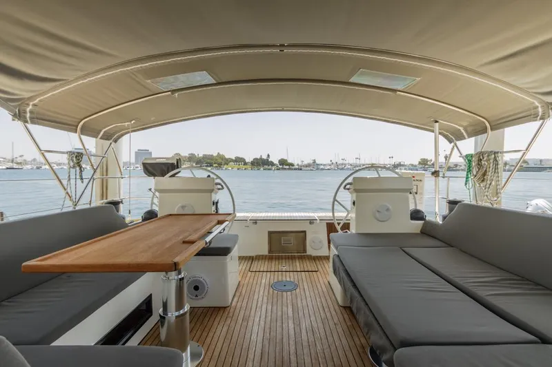 Slide: The Image of Spacious deck of 2022 Bavaria C50 yacht with seating and table, overlooking marina. - 17
