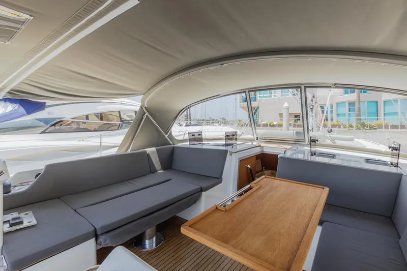 Slide: The Image of Luxurious 2022 Bavaria C50 yacht interior with spacious seating and wooden table. - 25