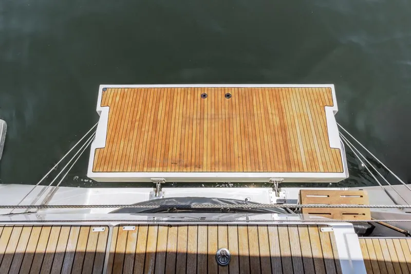 Slide: The Image of Bavaria C50 2022 yacht with teak swim platform on calm water. - 26