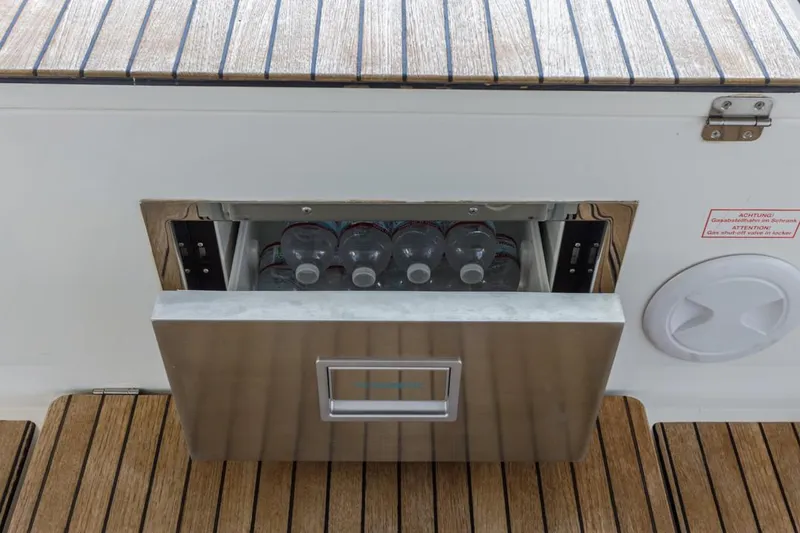 Slide: The Image of Built-in cooler with bottled water on Bavaria C50 yacht, 2022 model, teak deck. - 28