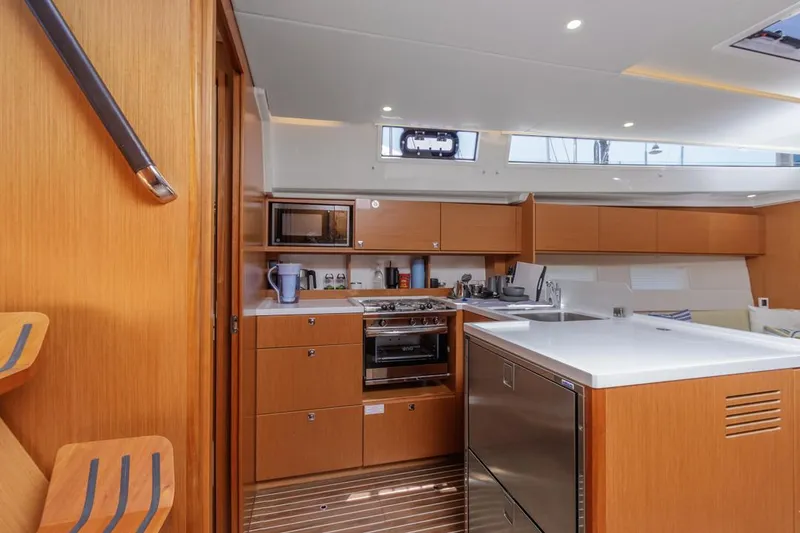 Slide: The Image of Modern kitchen interior of 2022 Bavaria C50 yacht with wood cabinetry and sleek appliances. - 34