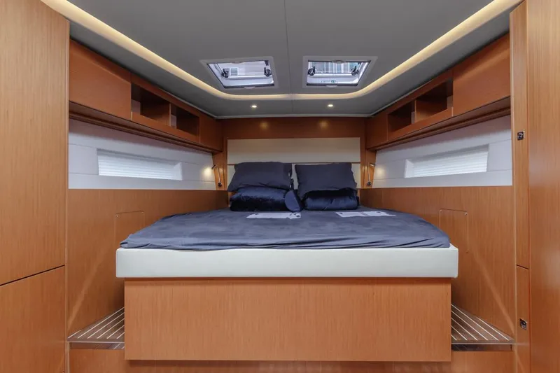 Slide: The Image of Luxurious 2022 Bavaria C50 yacht cabin with modern wood finish and skylights. - 38