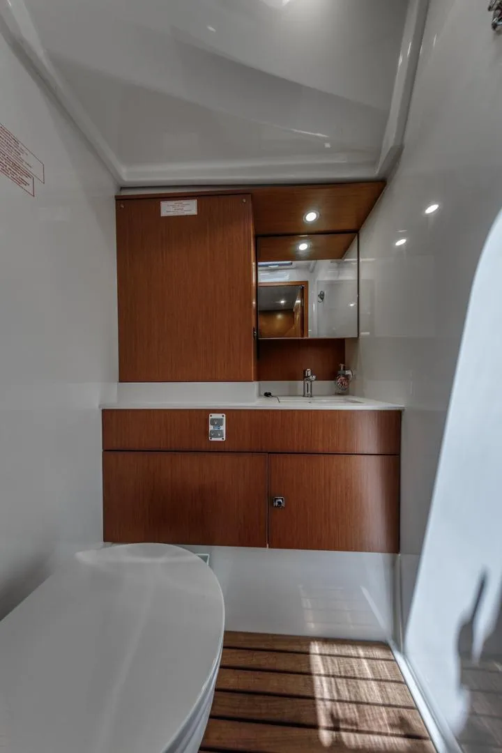 Slide: The Image of 2022 Bavaria C50 yacht bathroom with modern wood cabinetry and sleek design. - 41