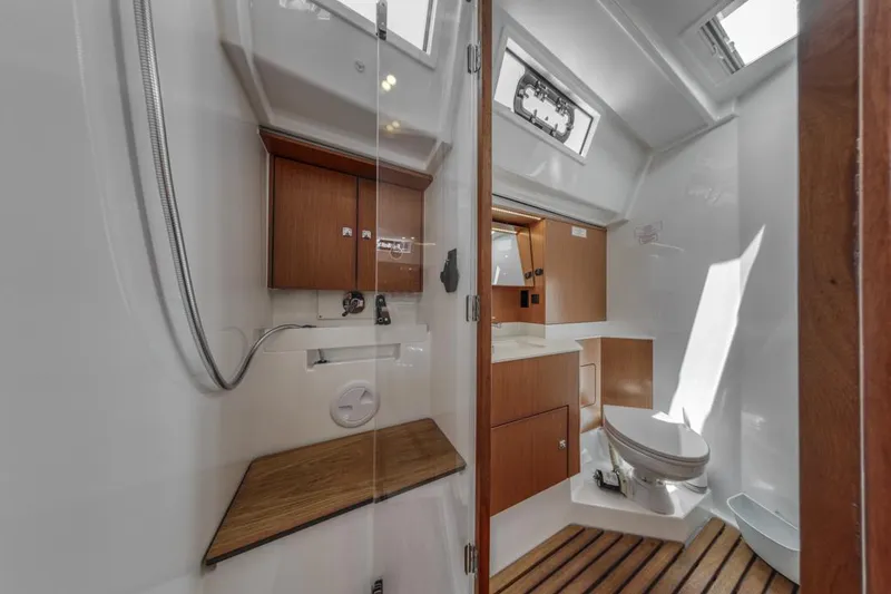 Slide: The Image of 2022 Bavaria C50 yacht bathroom with wooden accents and modern fixtures. - 48