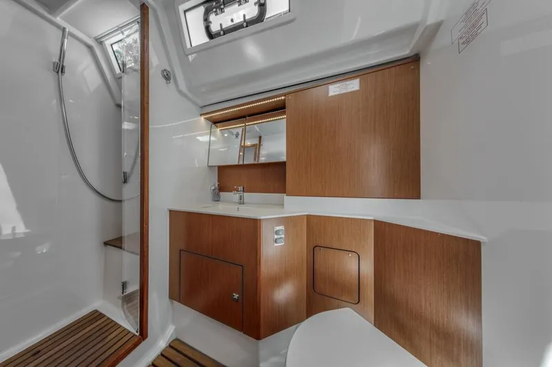Slide: The Image of Modern bathroom interior of 2022 Bavaria C50 yacht with wood accents and shower. - 49