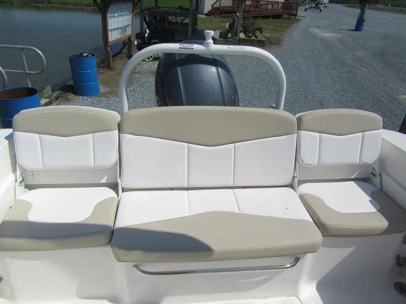 Slide: The Image of 2019 Robalo R207 Dual Console boat seating with beige and white cushions. - 12
