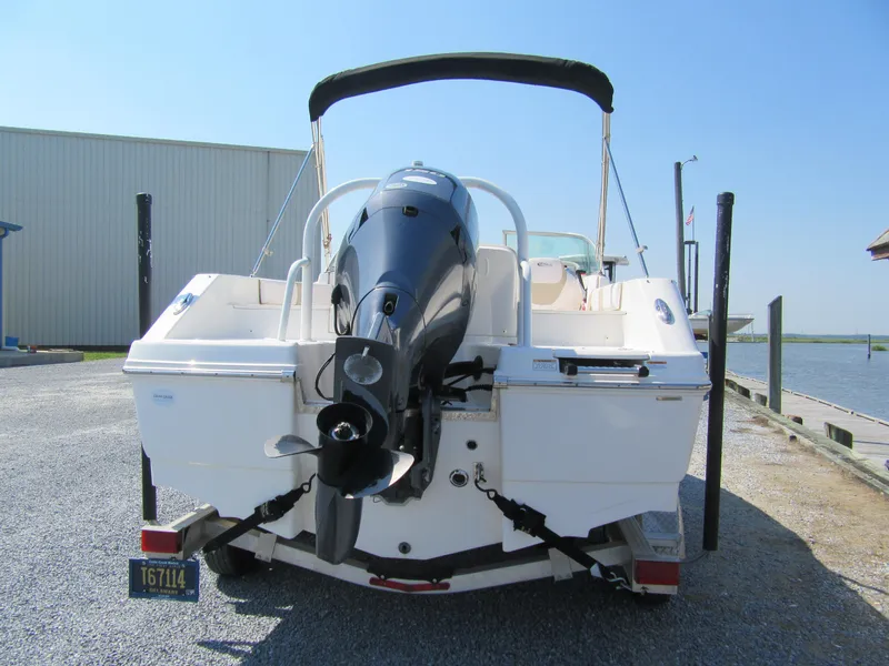 Slide: The Image of 2019 Robalo R207 Dual Console boat with outboard motor, parked on trailer. - 13