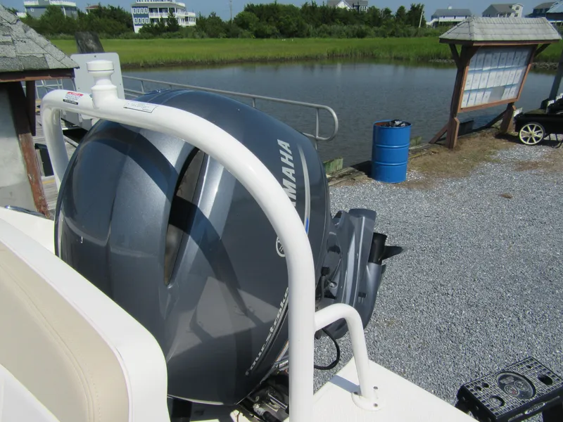 Slide: The Image of 2019 Robalo R207 Dual Console with Yamaha outboard motor by a lake. - 5