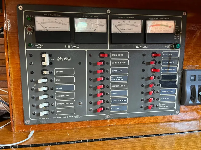 Slide: The Image of 1976 Hans Christian 38T electrical control panel with AC and DC switches and meters. - 17