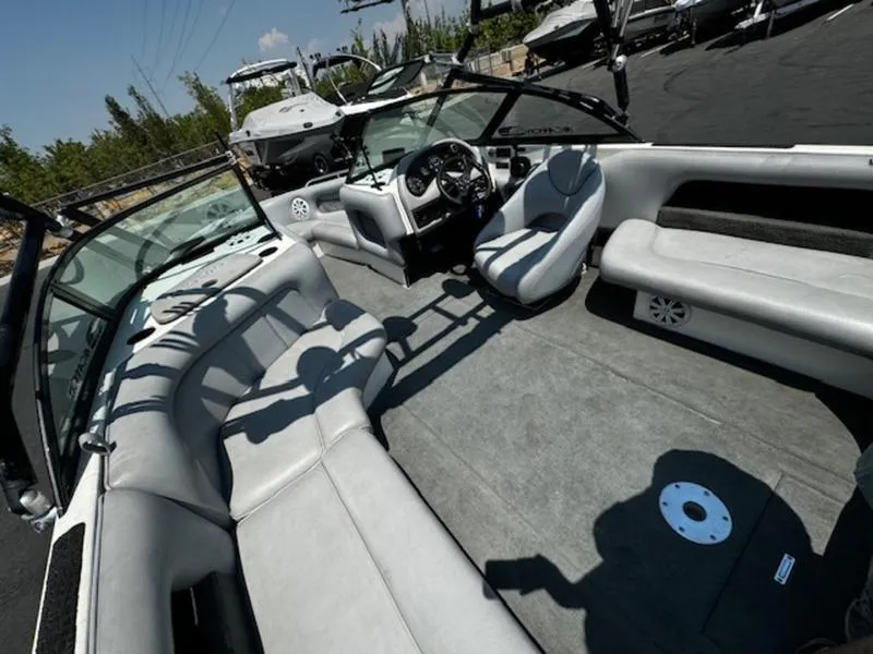 Slide: The Image of 2004 Calabria PRO-V boat interior with gray seating and steering console. - 10