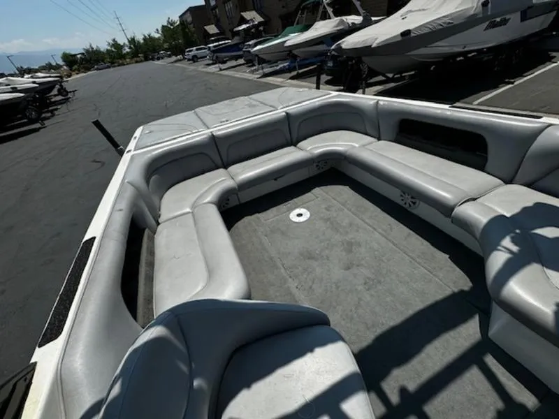 Slide: The Image of 2004 Calabria PRO-V boat interior with spacious seating in a parking lot. - 11