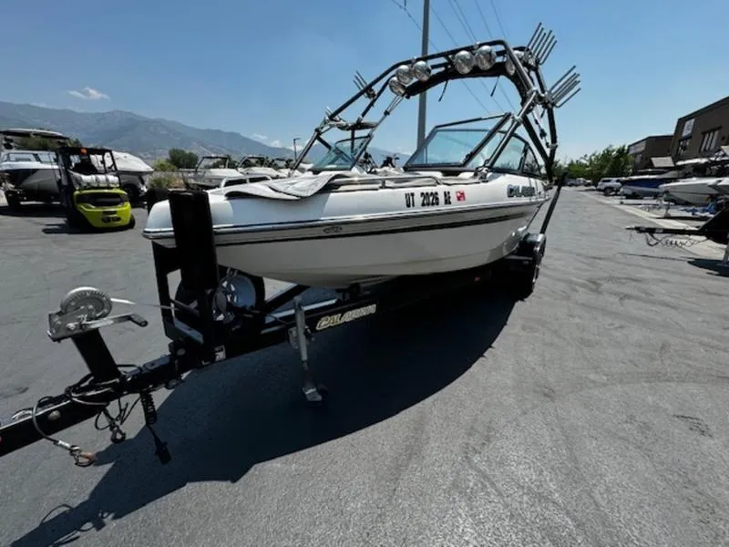 Slide: The Image of 2004 Calabria PRO-V boat on trailer, parked outdoors under clear sky. - 2