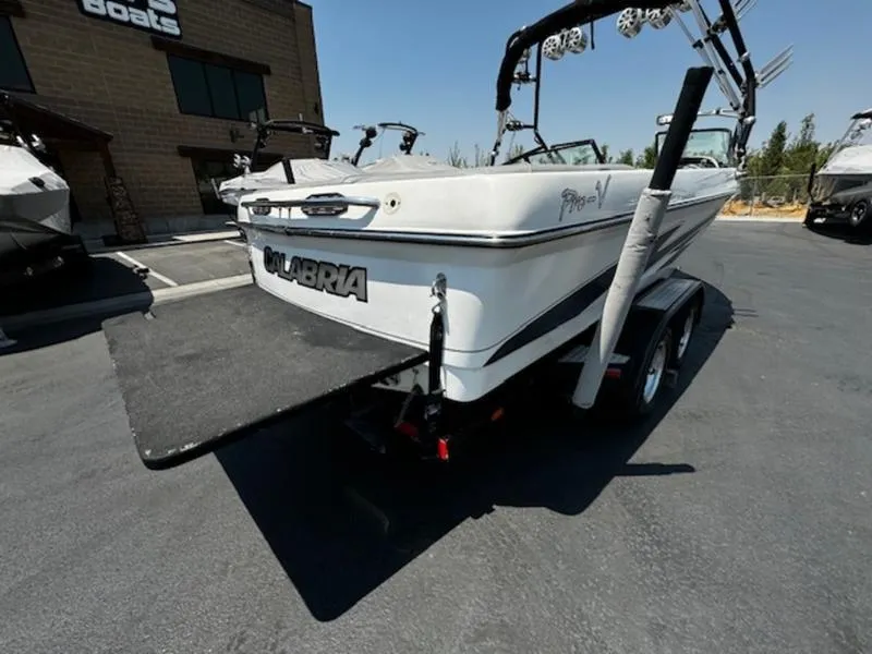 Slide: The Image of 2004 Calabria PRO-V boat on trailer, rear view, parked outdoors. - 5