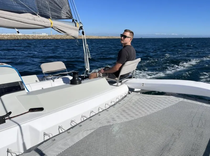 Slide: The Image of Person sailing on a Corsair 880 Standard trimaran, 2024 model. - 2