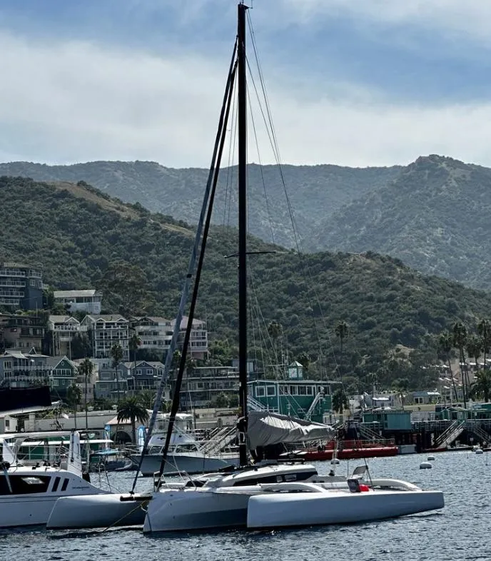 Slide: The Image of 2024 Corsair 880 Standard trimaran docked with mountain backdrop. - 4