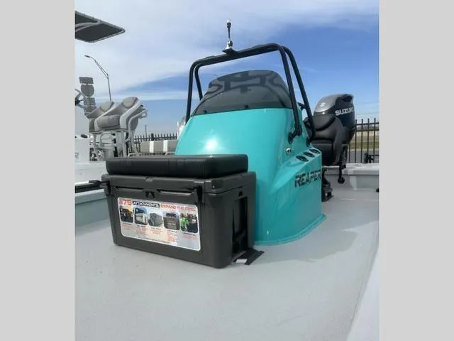 Slide: The Image of 2024 Majek Boats 24 REAPER with Suzuki engine, turquoise console, and seating. - 6