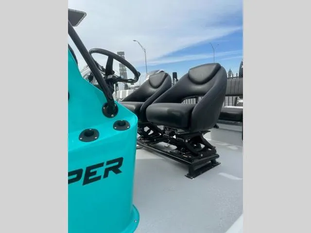 Slide: The Image of 2024 Majek Boats 24 REAPER interior with black seats and turquoise console. - 7