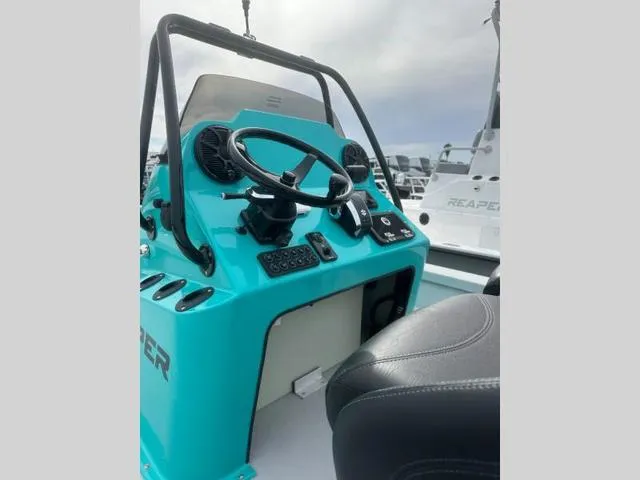 Slide: The Image of 2024 Majek Boats 24 REAPER console with steering wheel and controls. - 8