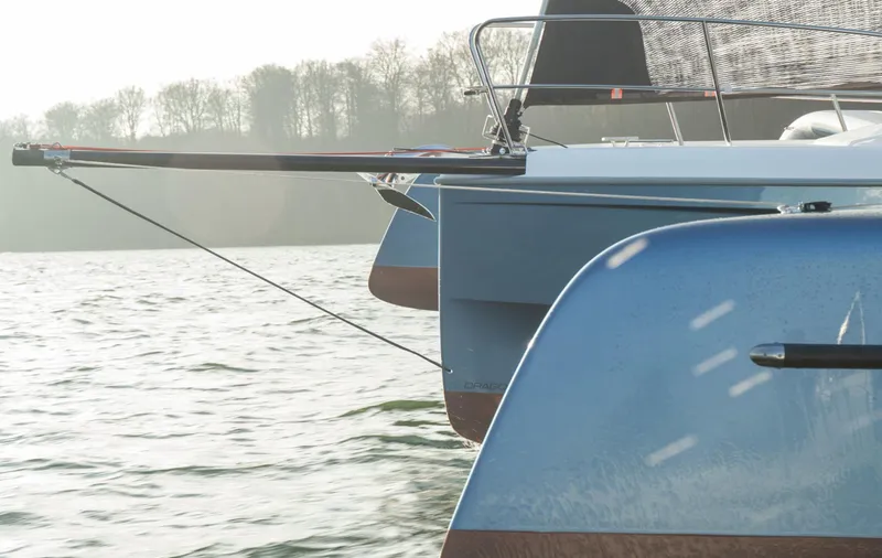 Slide: The Image of Sleek Dragonfly 32 trimaran sailing on a calm lake, 2026 model. - 2