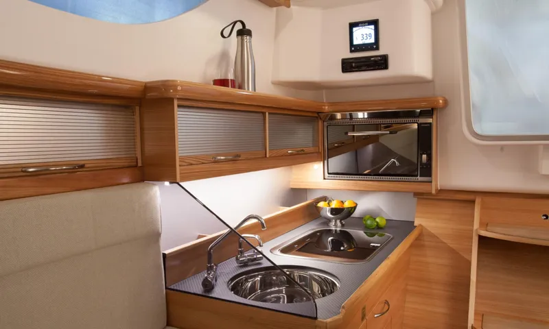 Slide: The Image of Modern kitchen interior in 2026 Dragonfly 32 yacht, featuring sleek wood cabinetry and stainless steel sink. - 5