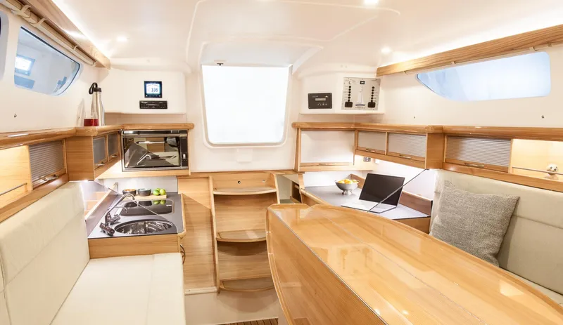 Slide: The Image of Luxurious interior of 2026 Dragonfly 32 sailboat with modern kitchen and seating area. - 6