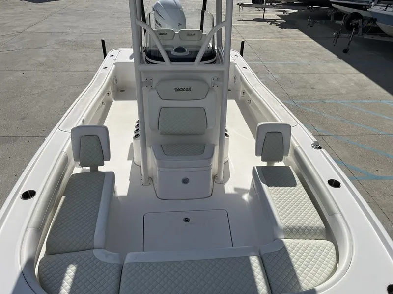 Slide: The Image of 2021 Caymas 26 HB boat interior with cushioned seating and center console. - 10