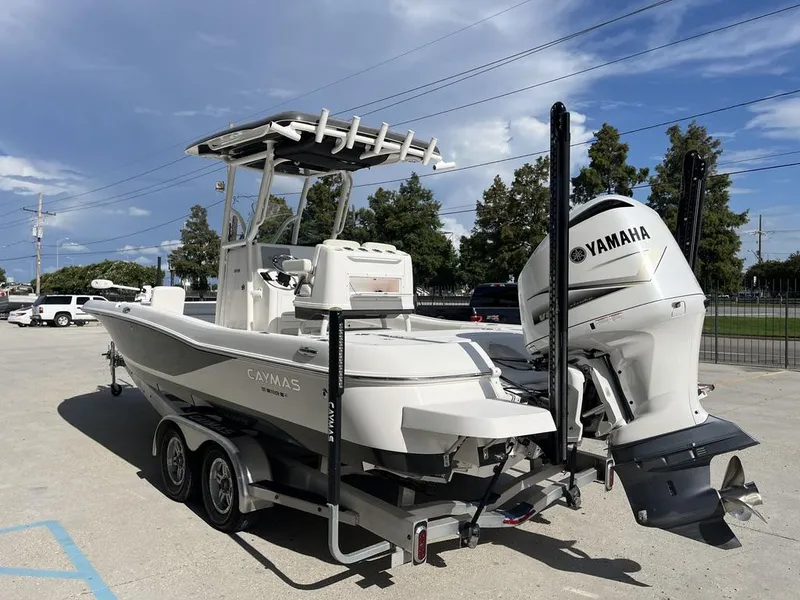 Slide: The Image of 2021 Caymas 26 HB boat with Yamaha engine on trailer, parked outdoors. - 13
