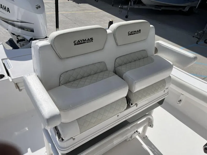 Slide: The Image of Caymas 26 HB 2021 boat seating with white cushioned seats and armrests. - 15