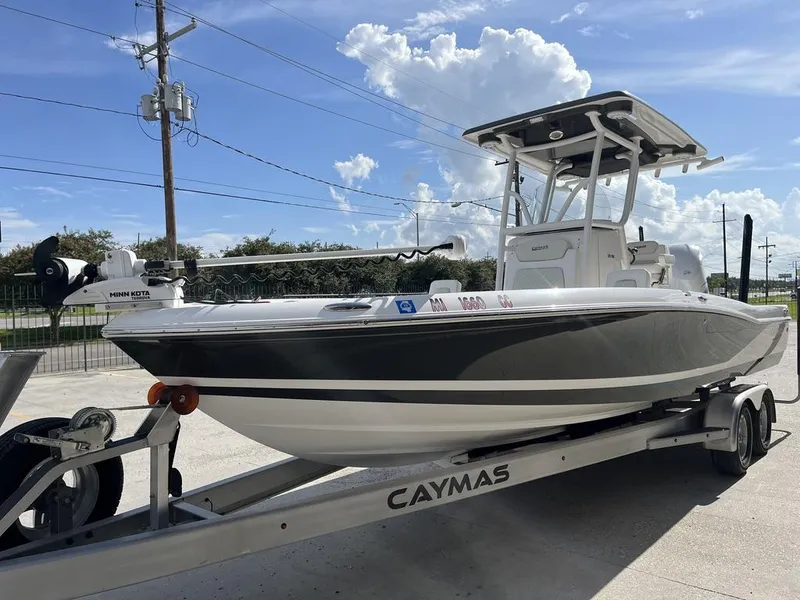 Slide: The Image of 2021 Caymas 26 HB boat on trailer, featuring Minn Kota trolling motor. - 3