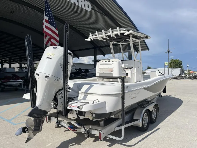 Slide: The Image of 2021 Caymas 26 HB boat with V8 engine on trailer, parked outdoors. - 6