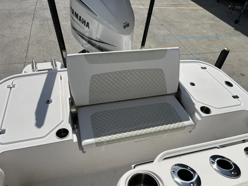 Slide: The Image of 2021 Caymas 26 HB boat with Yamaha engine, featuring a cushioned seat and cup holders. - 8