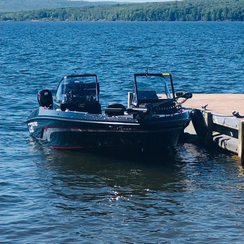 Slide: The Image of 2021 Nitro ZV20 Pro boat docked on a serene lake. - 2