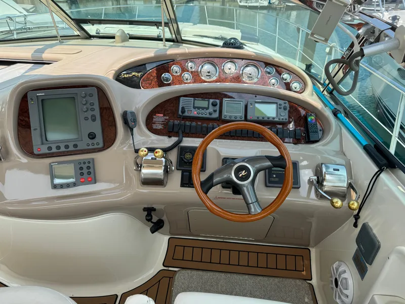 Slide: The Image of Cockpit of 2001 Sea Ray 380 Sundancer with navigation instruments and wooden steering wheel. - 11