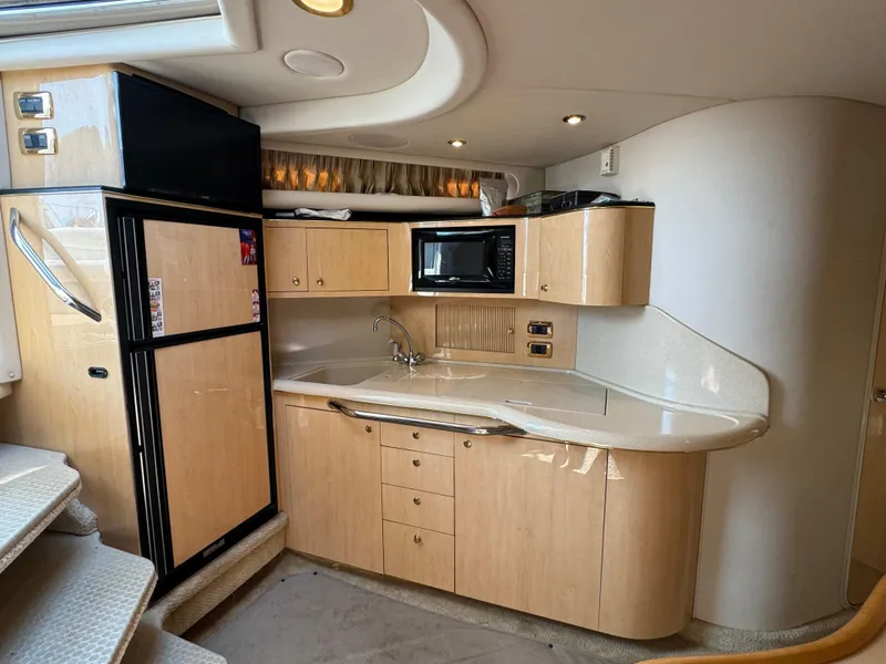 Slide: The Image of 2001 Sea Ray 380 Sundancer yacht kitchen with modern appliances and sleek cabinetry. - 13