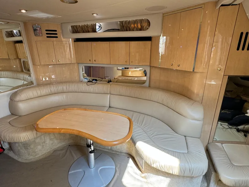 Slide: The Image of Interior of 2001 Sea Ray 380 Sundancer with beige leather seating and wooden cabinetry. - 15