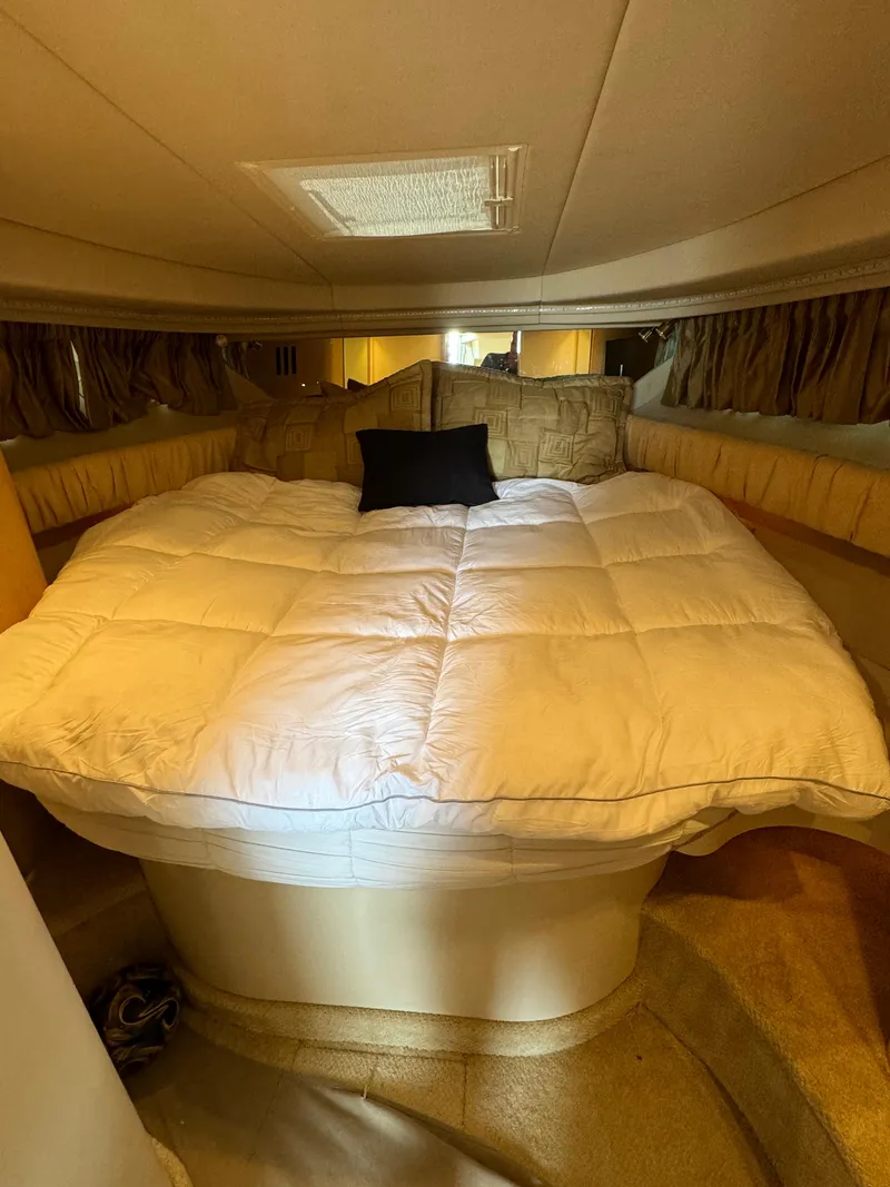 Slide: The Image of Cozy cabin interior of 2001 Sea Ray 380 Sundancer with plush bedding. - 18