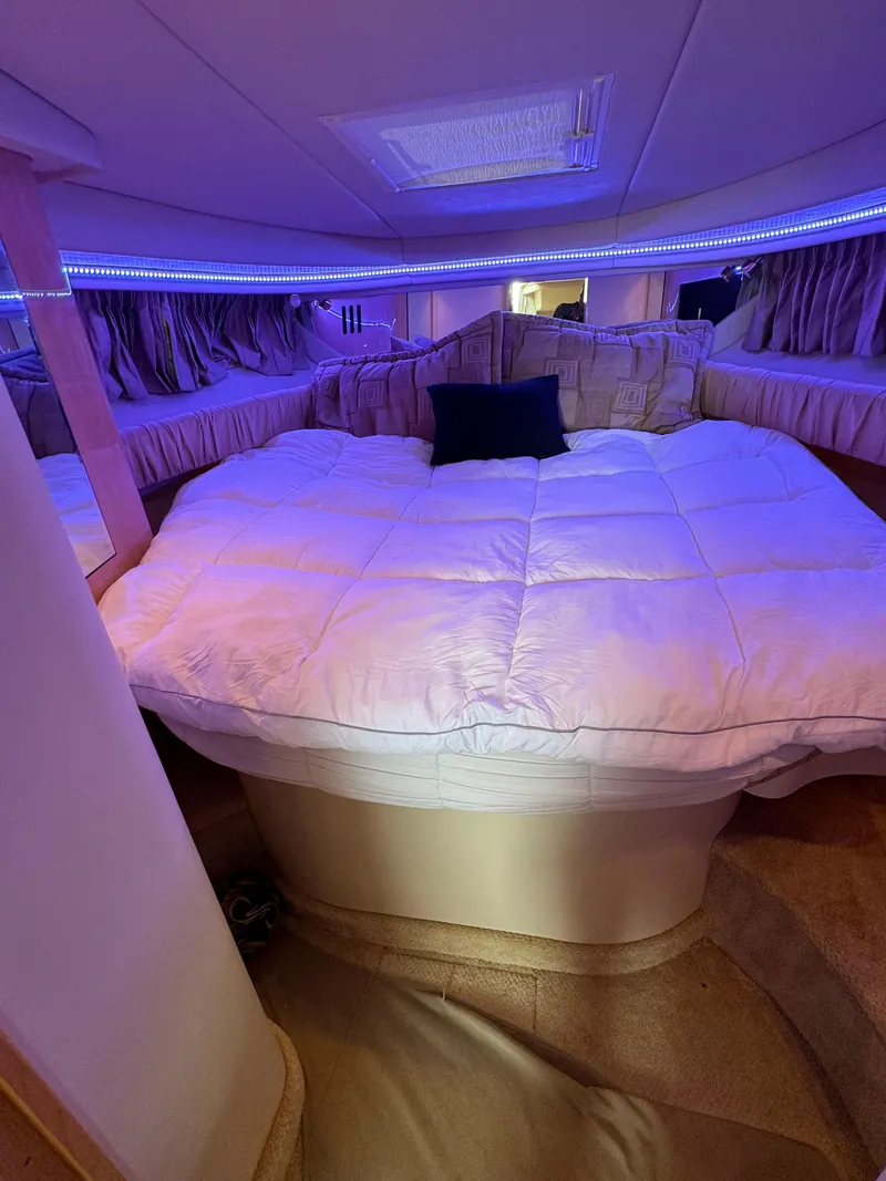 Slide: The Image of Luxurious cabin interior of 2001 Sea Ray 380 Sundancer with cozy bedding and ambient lighting. - 19