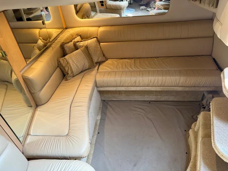 Slide: The Image of Luxurious interior of 2001 Sea Ray 380 Sundancer with beige leather seating and cushions. - 21