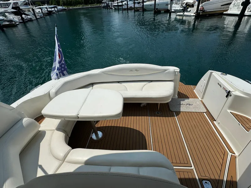 Slide: The Image of 2001 Sea Ray 380 Sundancer yacht with white seating and wooden deck in marina. - 5