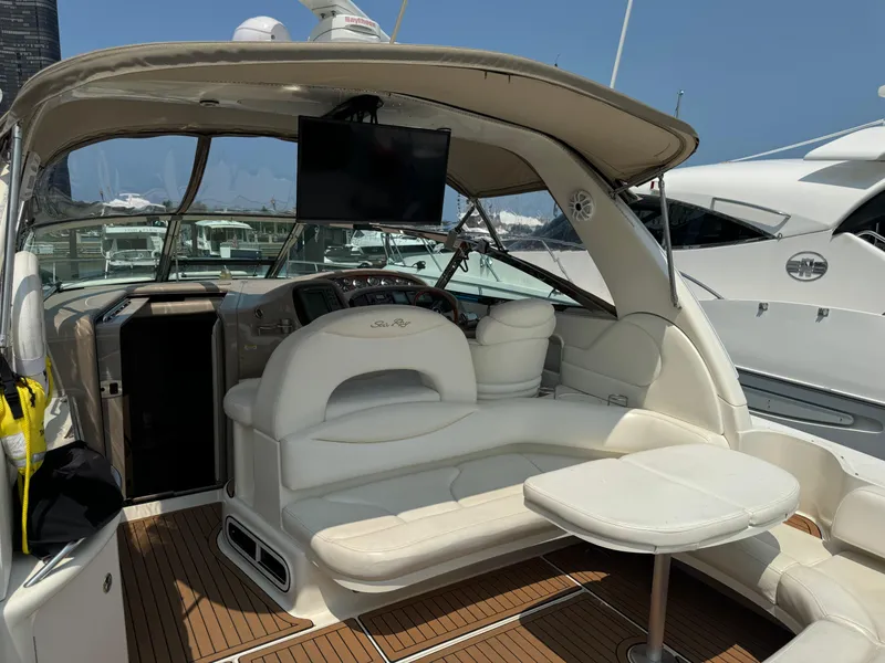 Slide: The Image of 2001 Sea Ray 380 Sundancer yacht interior with seating and table, docked at marina. - 6