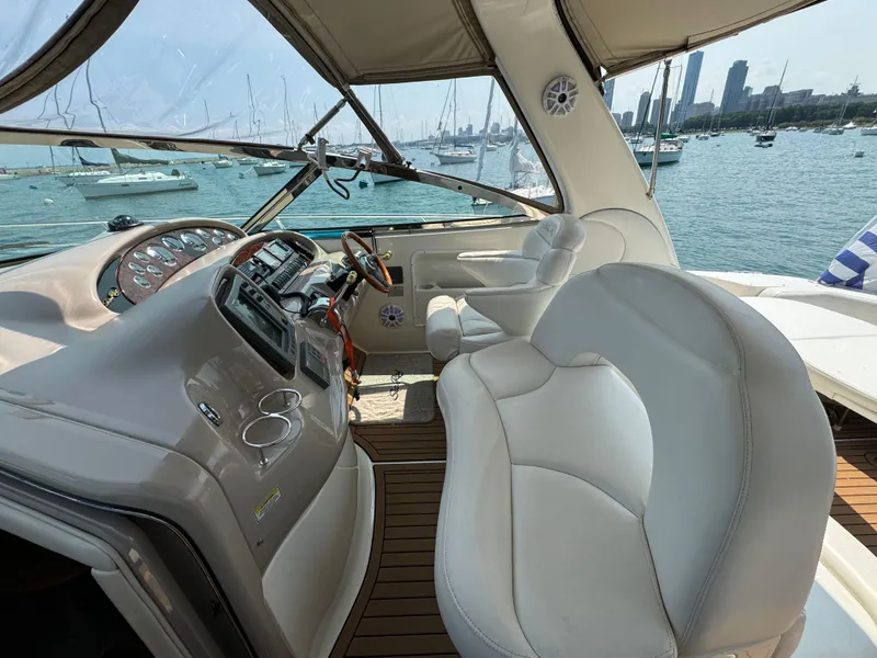 Slide: The Image of 2001 Sea Ray 380 Sundancer helm with luxurious seating and city skyline view. - 9