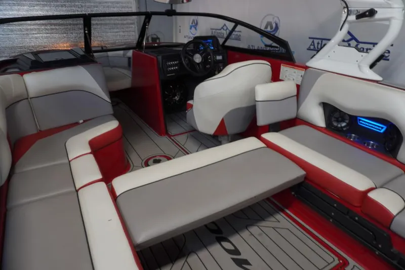 Slide: The Image of 2019 Moomba Craz MG boat interior with red and gray seating, modern dashboard, and sleek design. - 10