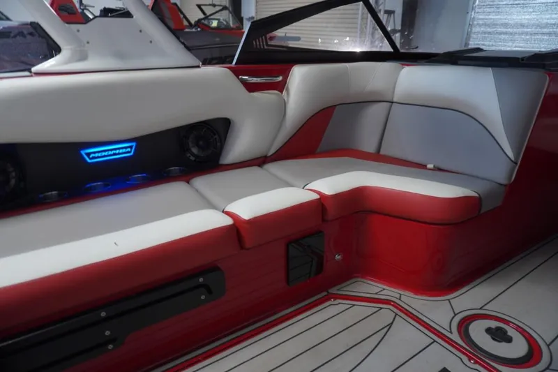 Slide: The Image of 2019 Moomba Craz MG boat interior with red and white seating, illuminated speakers. - 11