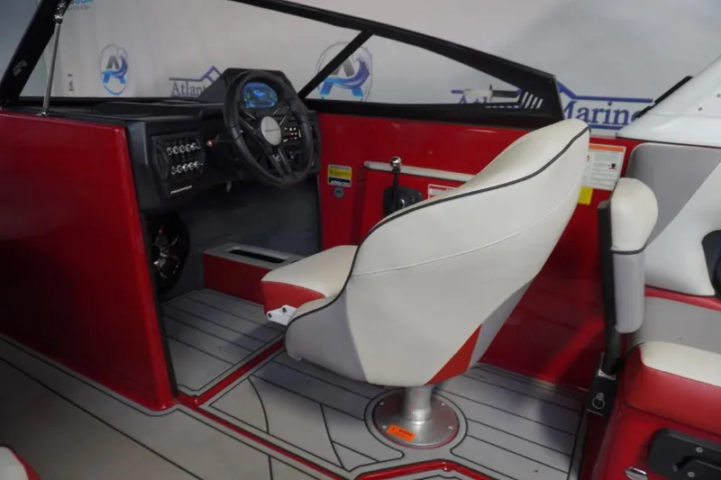 Slide: The Image of 2019 Moomba Craz MG boat interior with red and white seating and modern dashboard. - 13