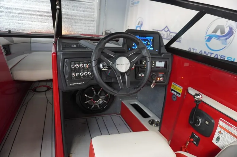 Slide: The Image of 2019 Moomba Craz boat interior with red accents and modern dashboard controls. - 14