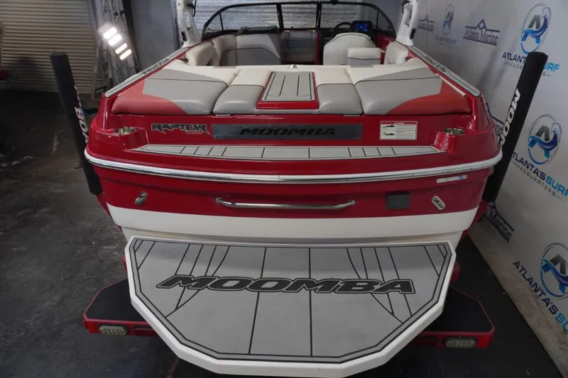 Slide: The Image of 2019 Moomba Craz MG boat, red and white, rear view in showroom. - 5