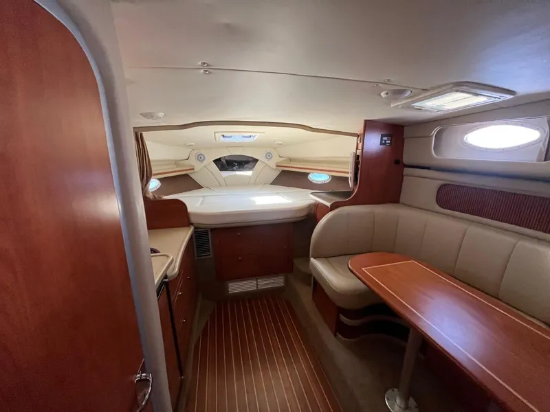 Slide: The Image of Interior of 2006 Rinker Fiesta Vee 342 yacht with cozy seating and wood finishes. - 13